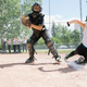 woman sliding into home base playing baseball